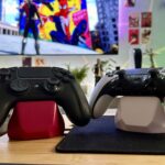 How to reset PS5 controller: two controllers on stands in front of a TV and a PS5 console